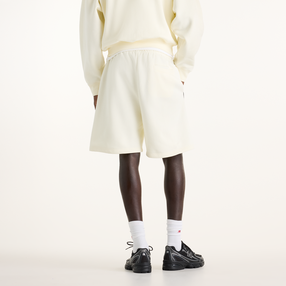 Pánské šortky New Balance Sport Linear Graphic – béžové