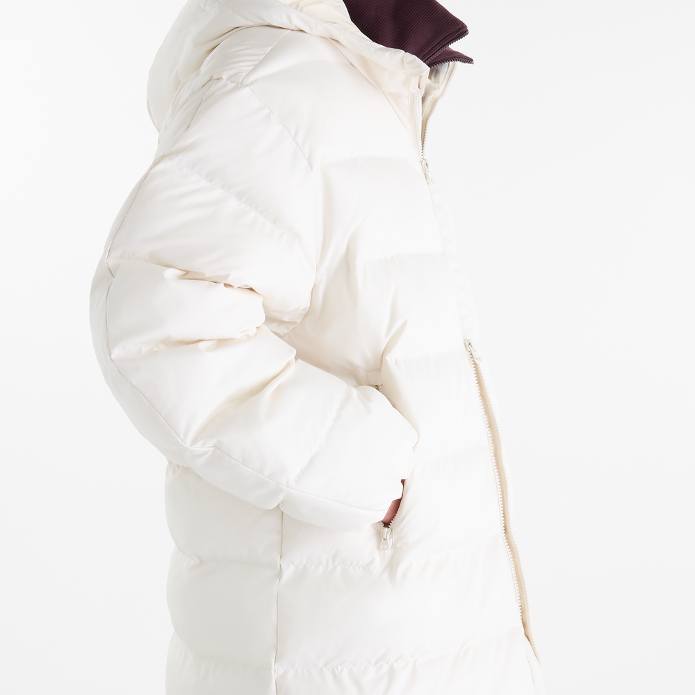 Dámská bunda New Balance Boston Long Puffer – béžové