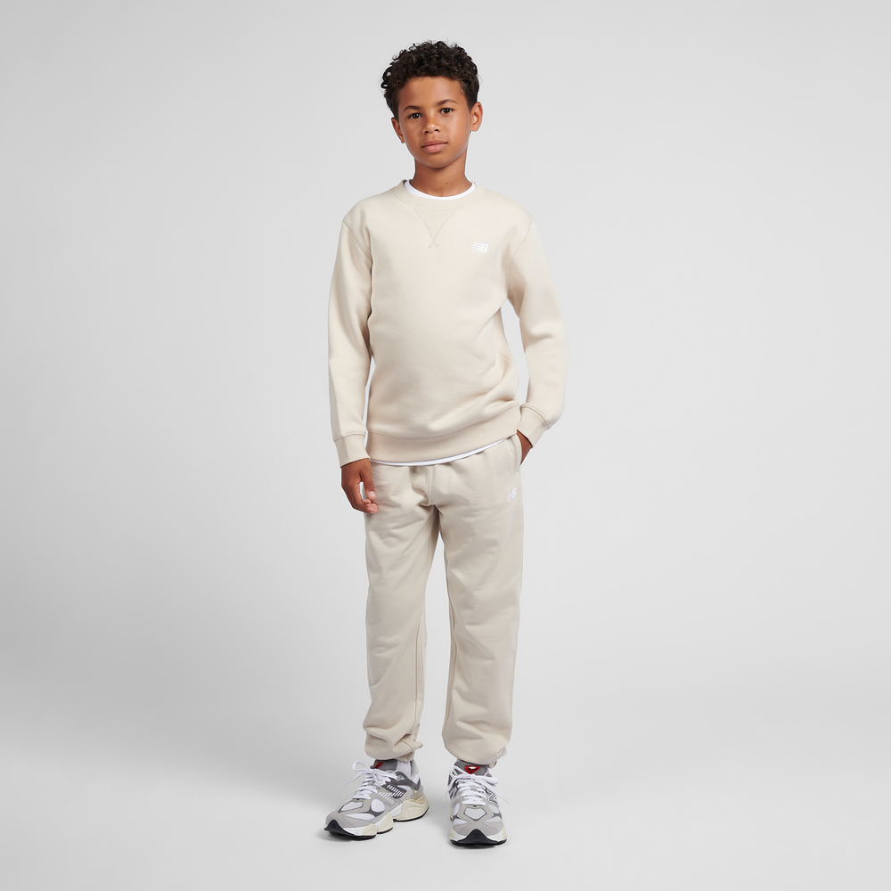 Dětské kalhoty New Balance LAKB0060TWF – béžové