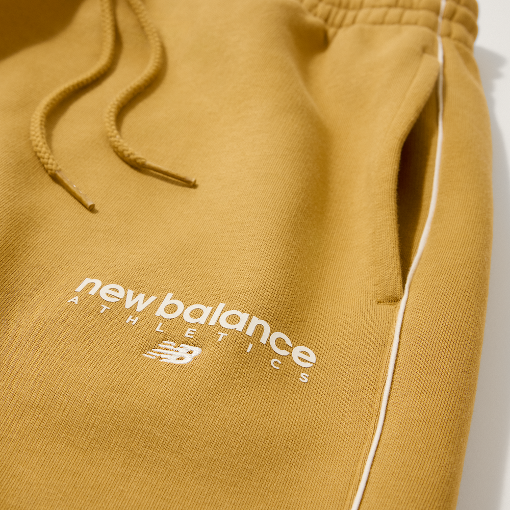 Pánské kalhoty New Balance MB61M77EABG – oranžová