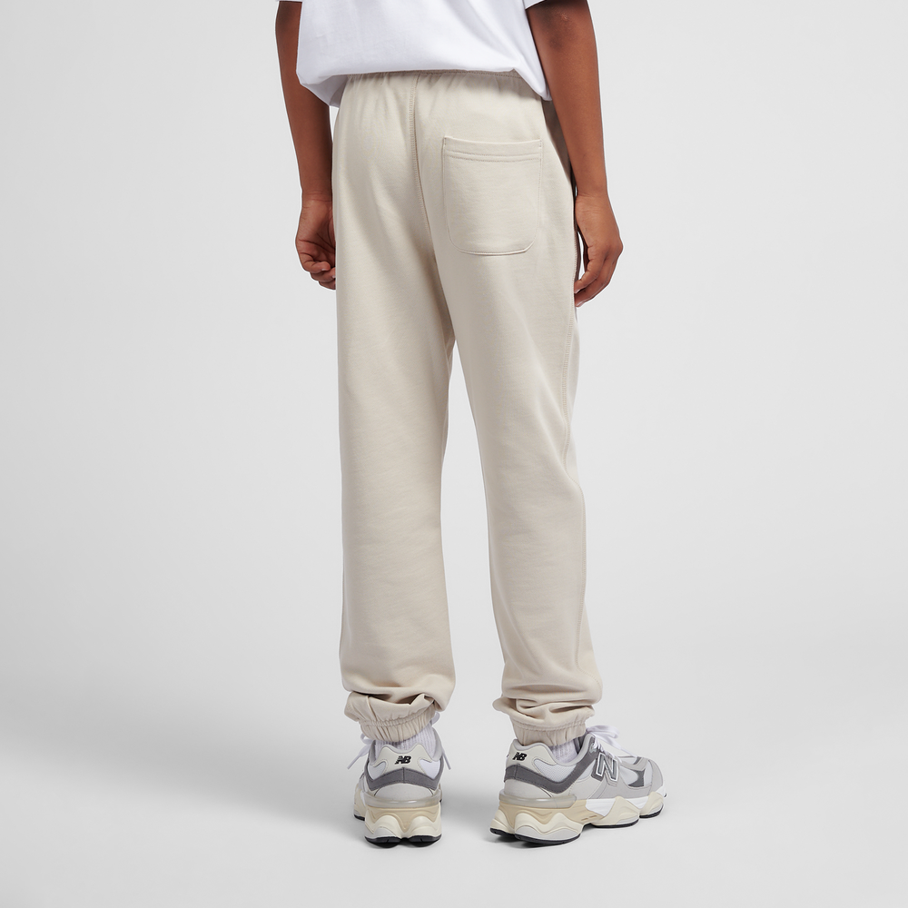 Dětské kalhoty New Balance LAKB0060TWF – béžové